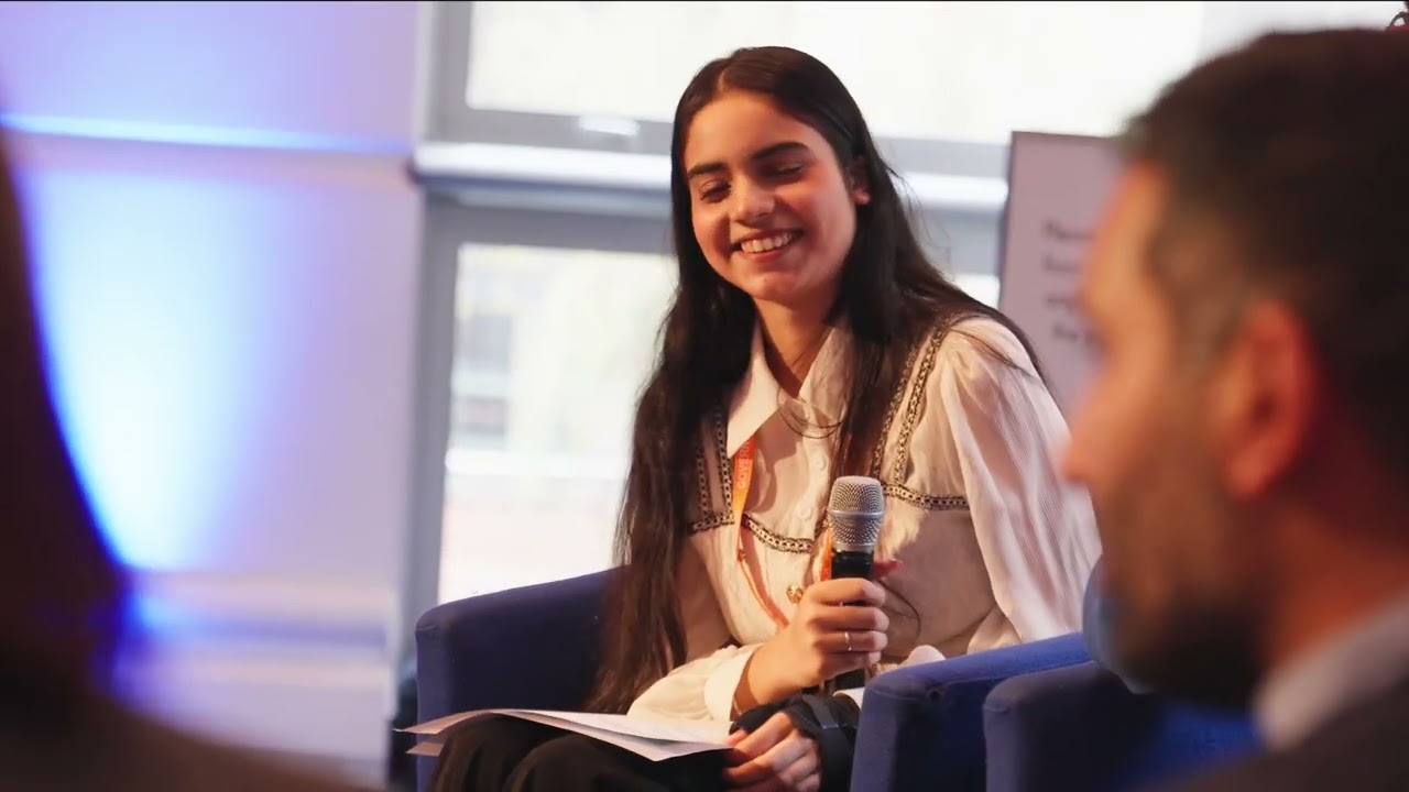student smiling with microphone