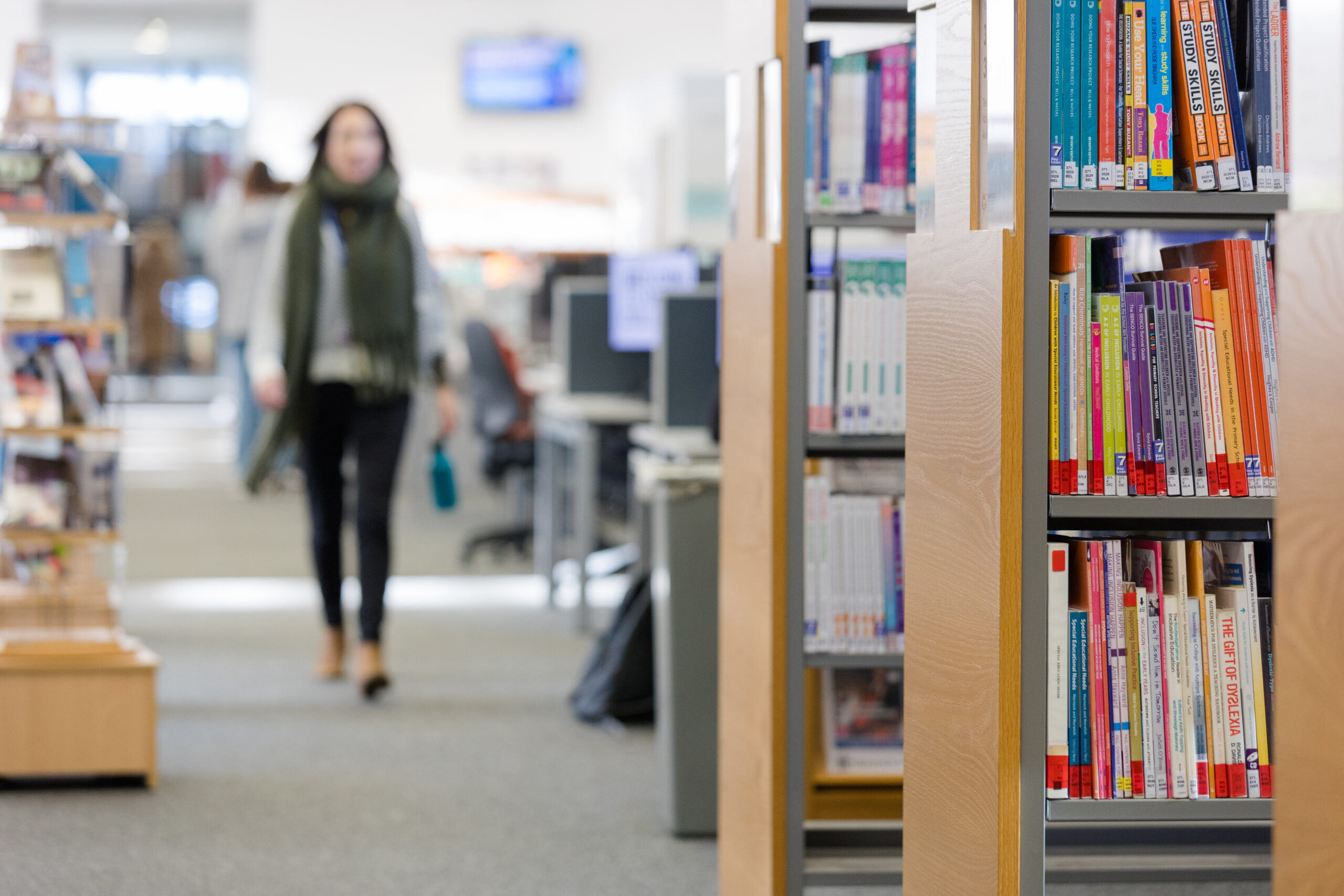 Woman walking in a library