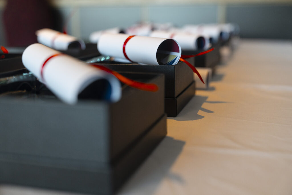 Award boxes with rolled up certificates placed on top